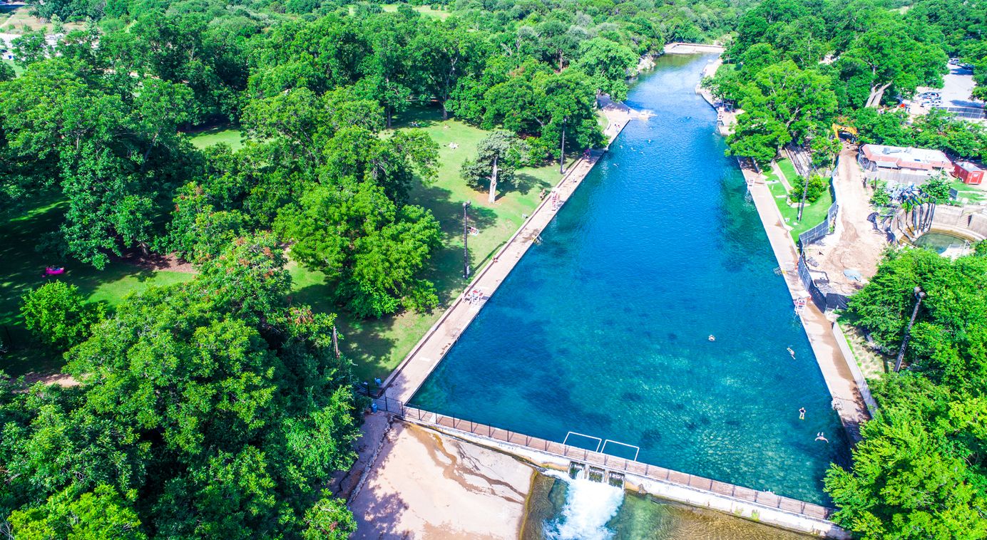 Looking across the Barton Springs Swimming Hole Turquoise Blue clear Spring water natural summer escape