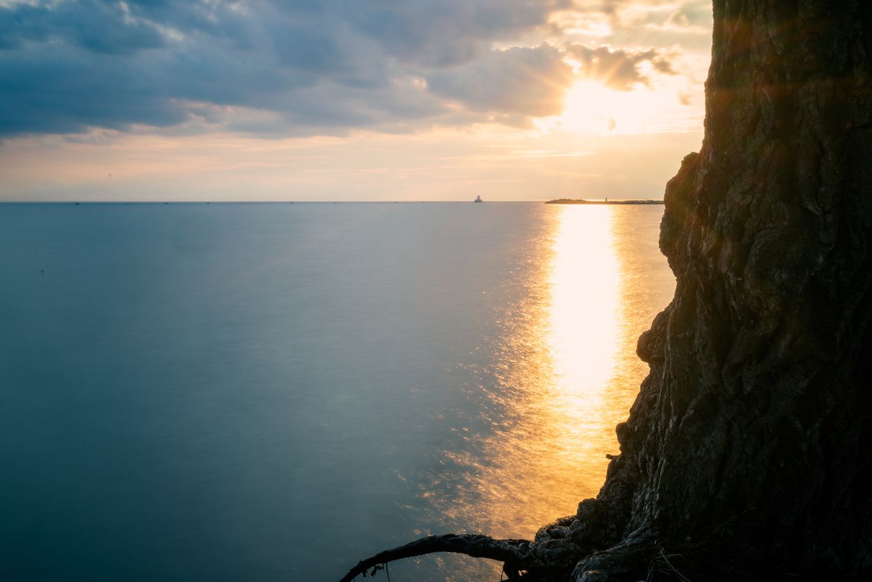 the sun setting in the horizon in Goderich, Ontario