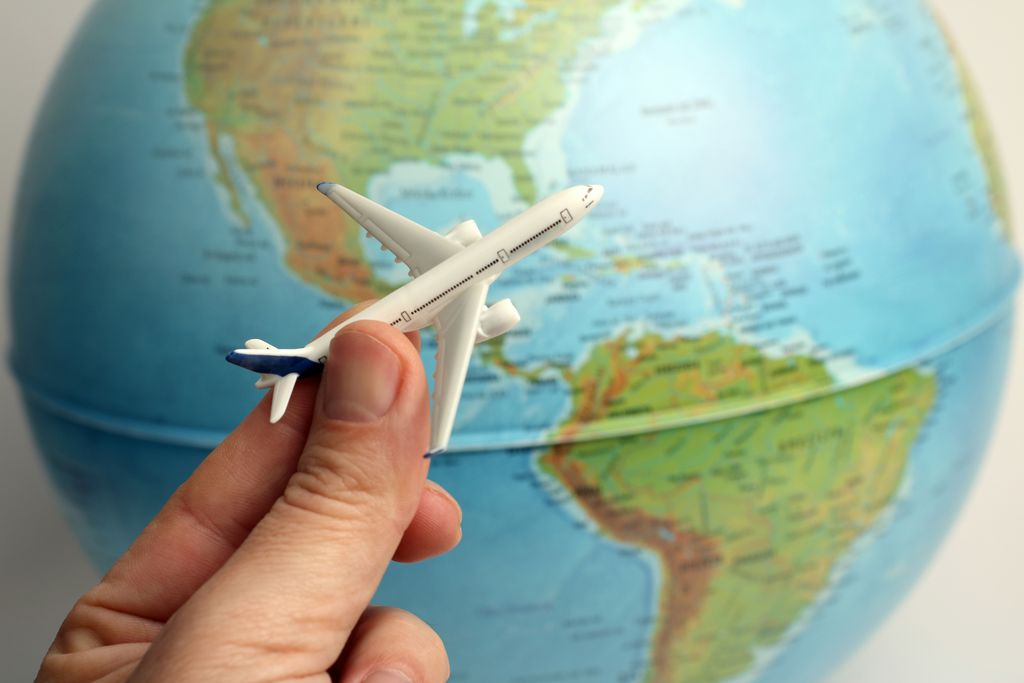 Airplane Travel concept with a toy airplane and the globe