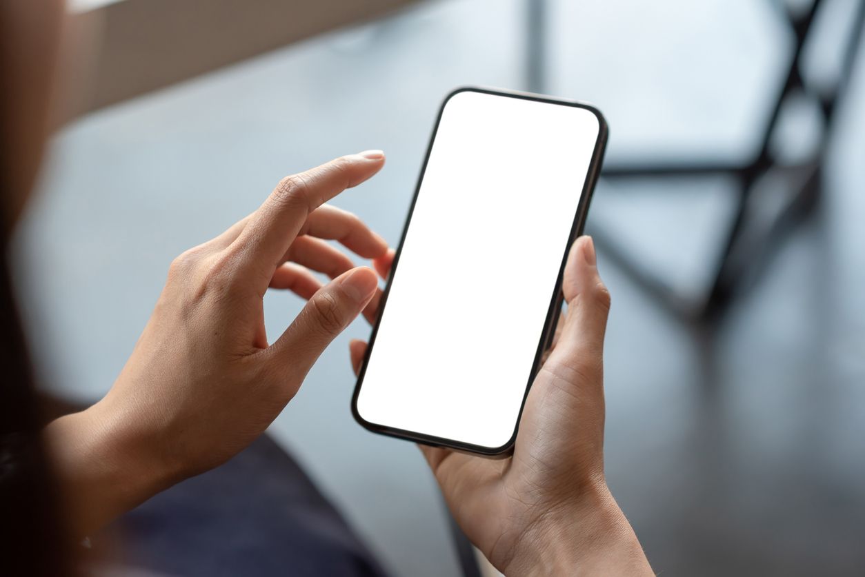 Close-up of a businessman hand holding a smartphone white screen is blank