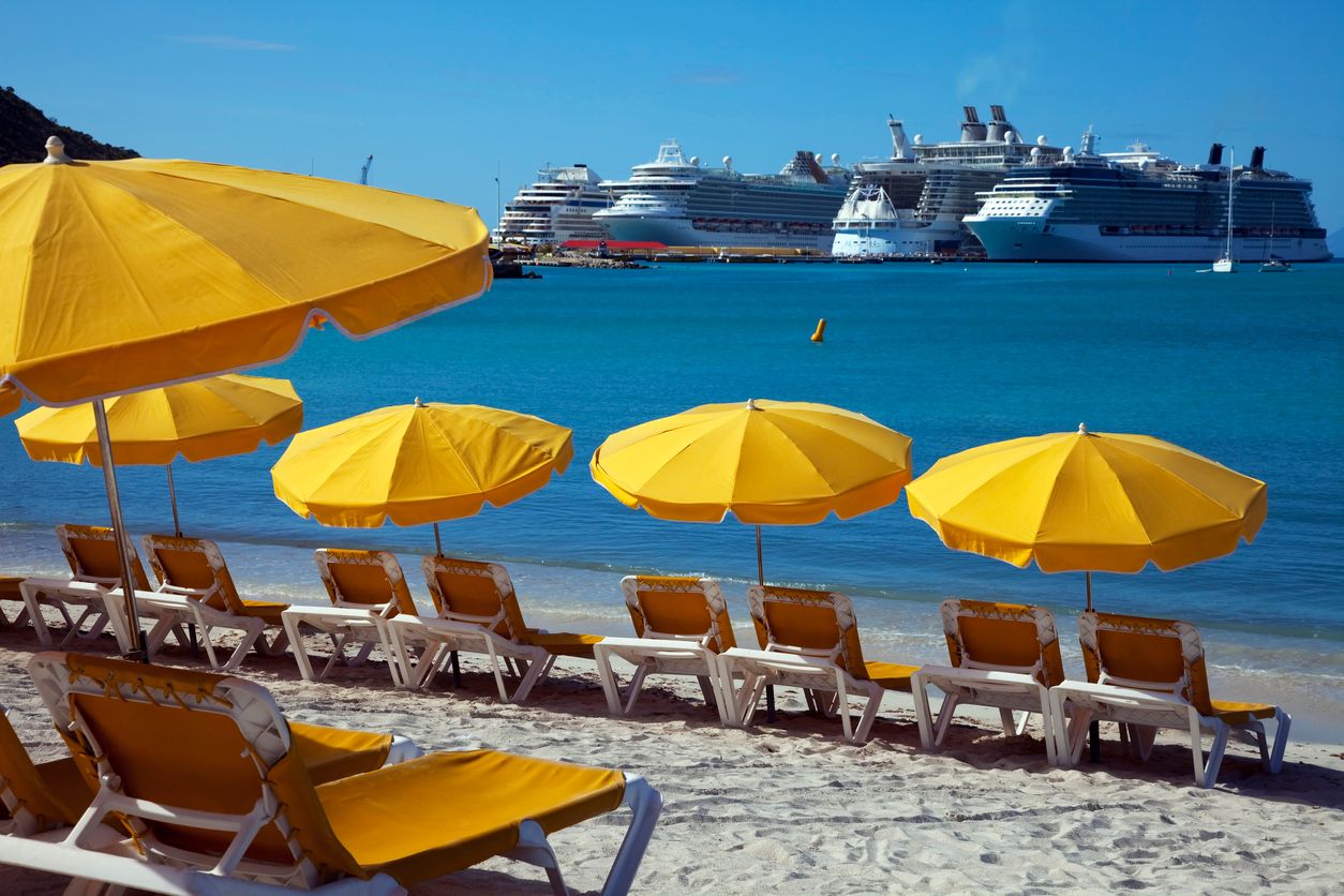 sun loungers await the passengers from the many docked cruise ships seen in the background
