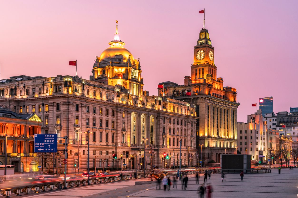 The Bund and the architecture in the former French Concession Area at night, with rush-hour traffic and light trails in Shanghai, China.
