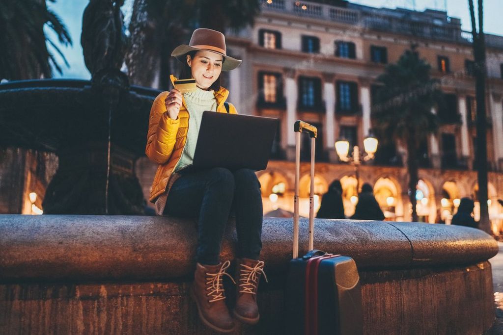 Woman in Barcelona booking hotel online.