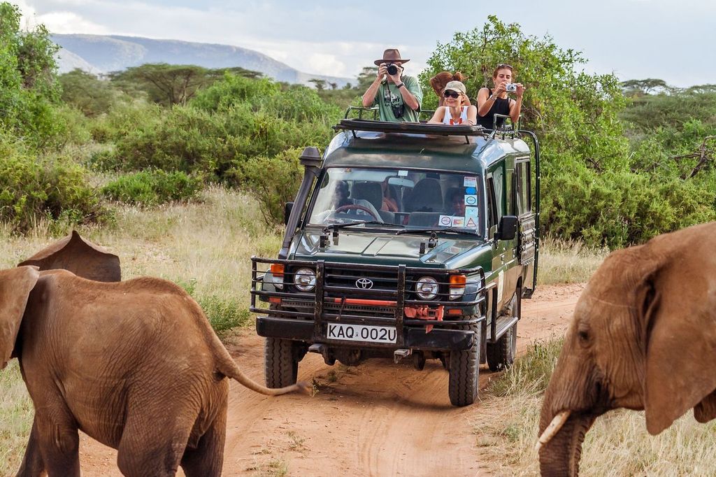 Tourists on safari game drive in Masai Mara, Kenya
