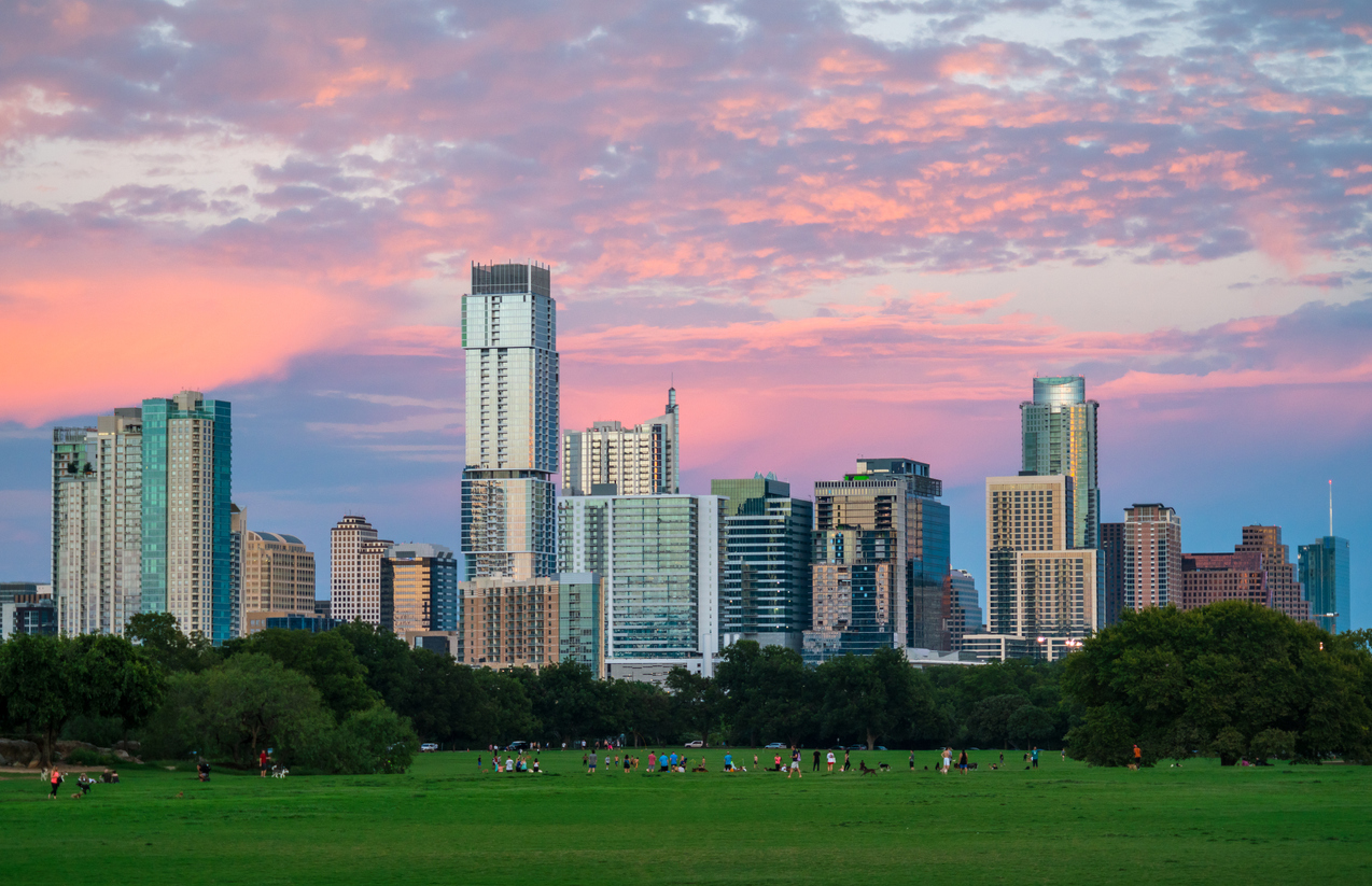 Zilker Park Sunset Austin Texas green grass landscape and perfect glowing Cityscape