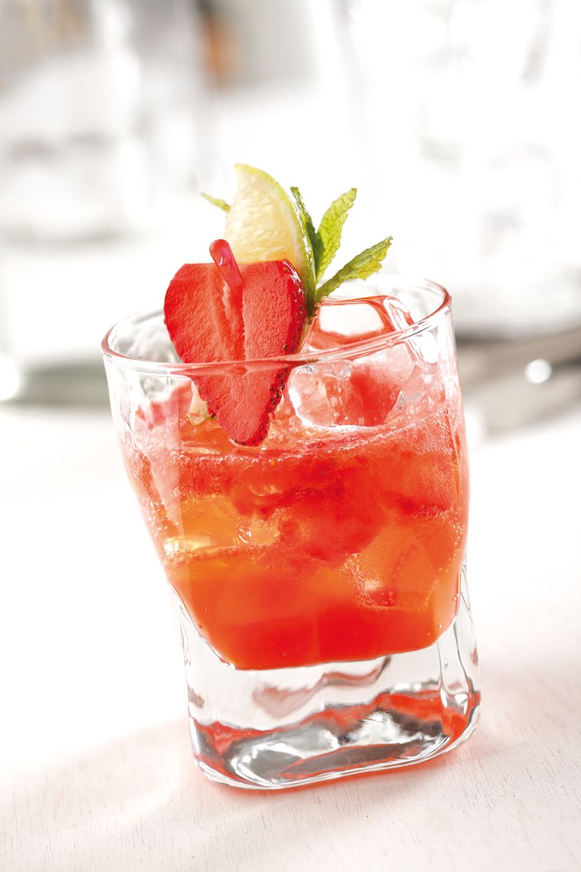Stock photo of a strawberry mojito cocktail, prepared with rum, strawberries, mint leaves, lime juice and soda.