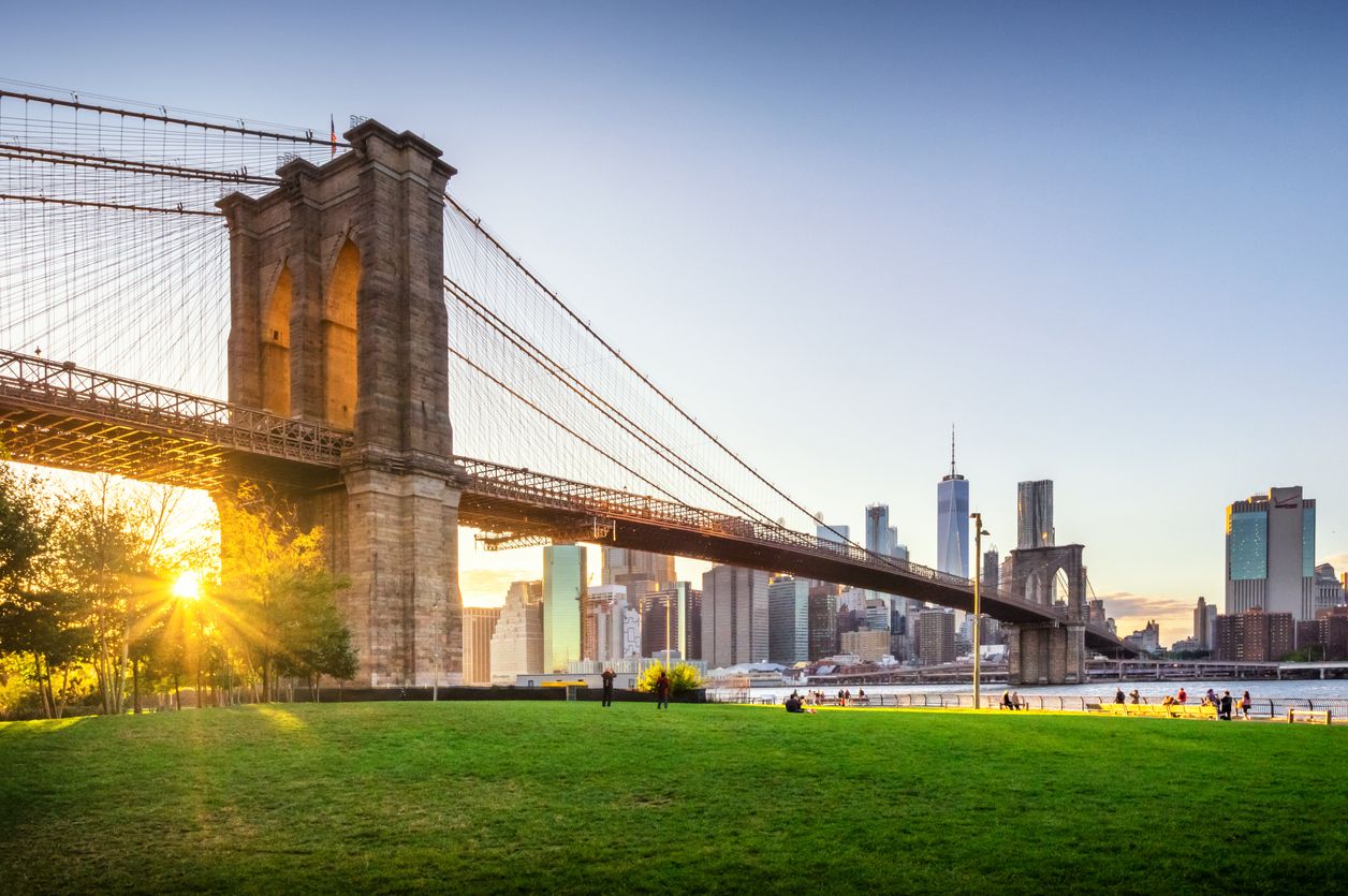 Brooklyn Bridge and Manhattan skyline at sunset, New York City, USA.