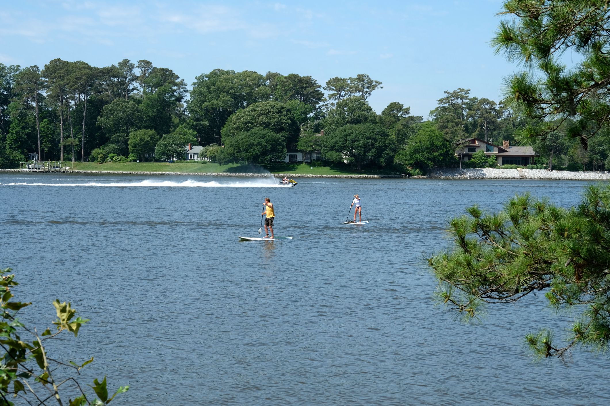 Virginia Beach, Virginia paddleboarders take to the water to cool off and enjoy the day at the beach