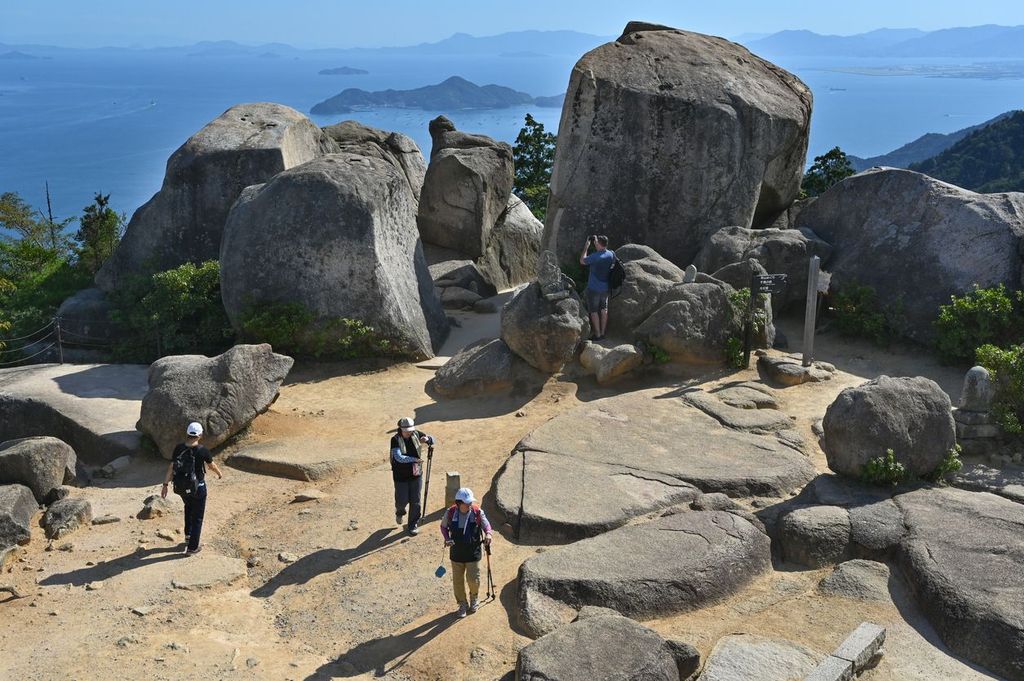 Mount Misen, Miyajima, Hiroshima, Japan with tourists hiking around at the top near Kuguri-iwa rock