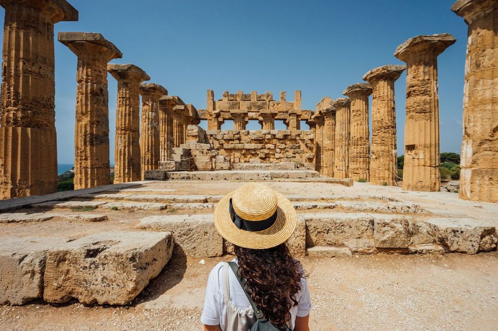 Solo woman admiring an ancient temple in Sicily