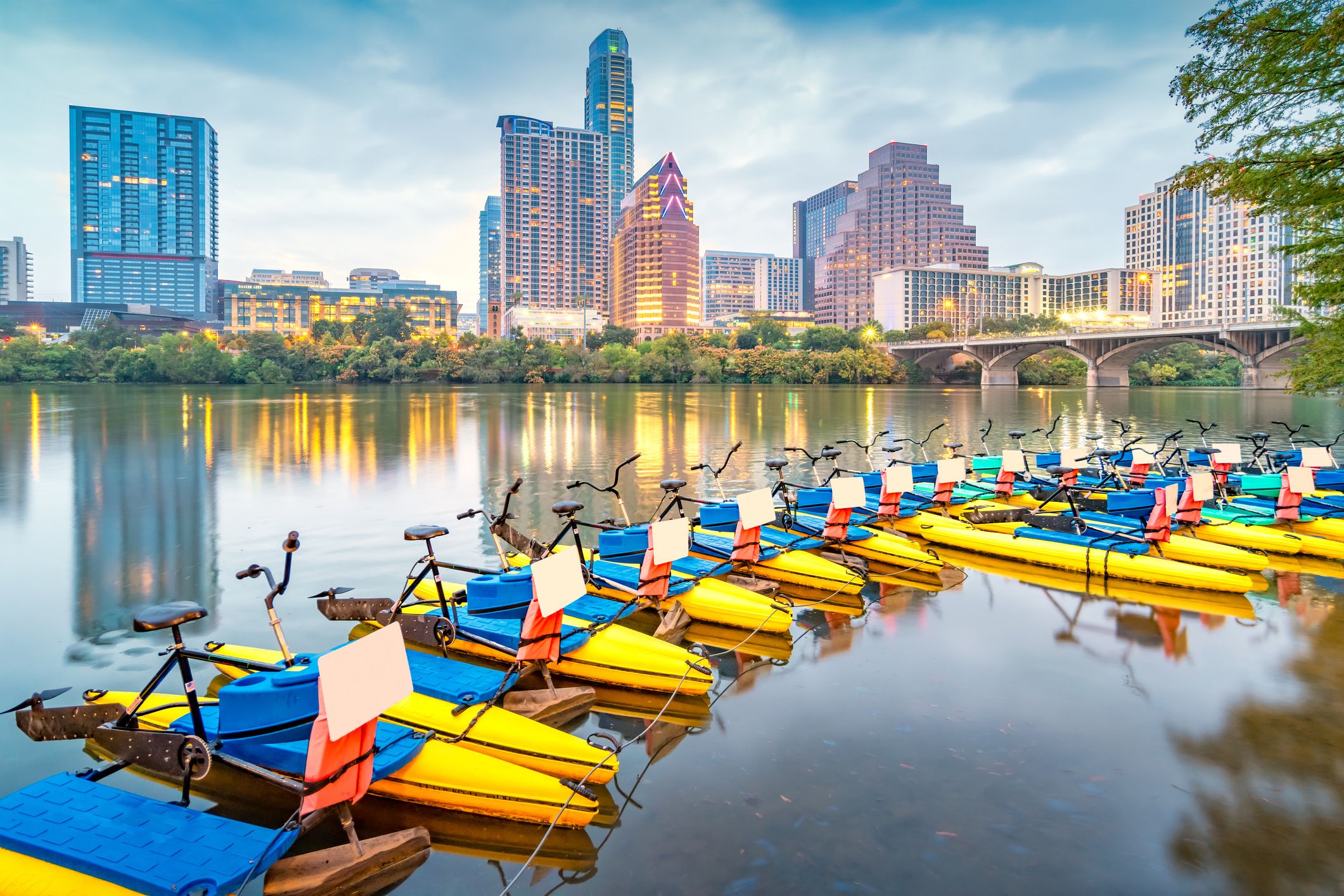 Water Bikes in the Colorado River and the skyline of Austin, Texas, USA