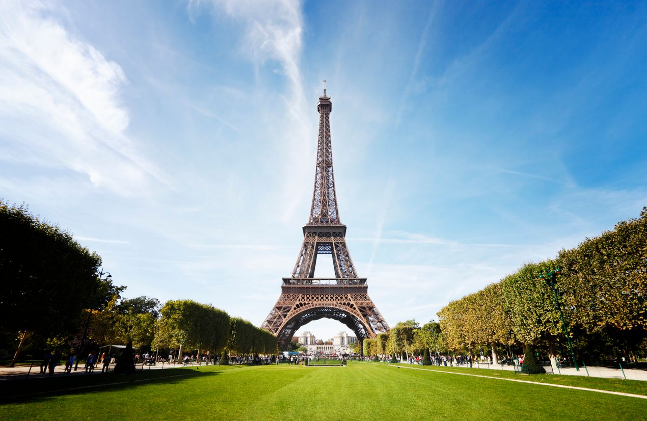 Wide angle shot of the Eiffel Tower taken from the Champ de Mars