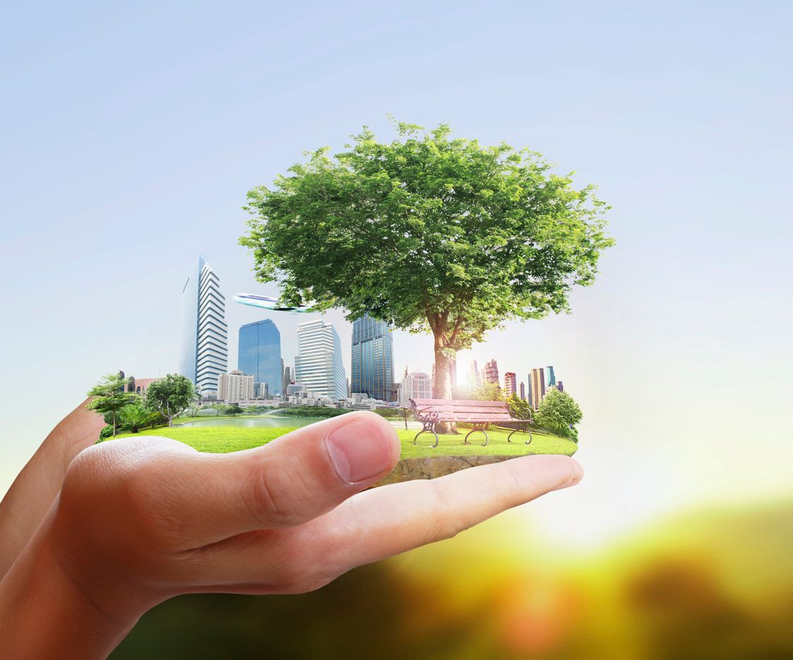 Human holding a city in their hands.