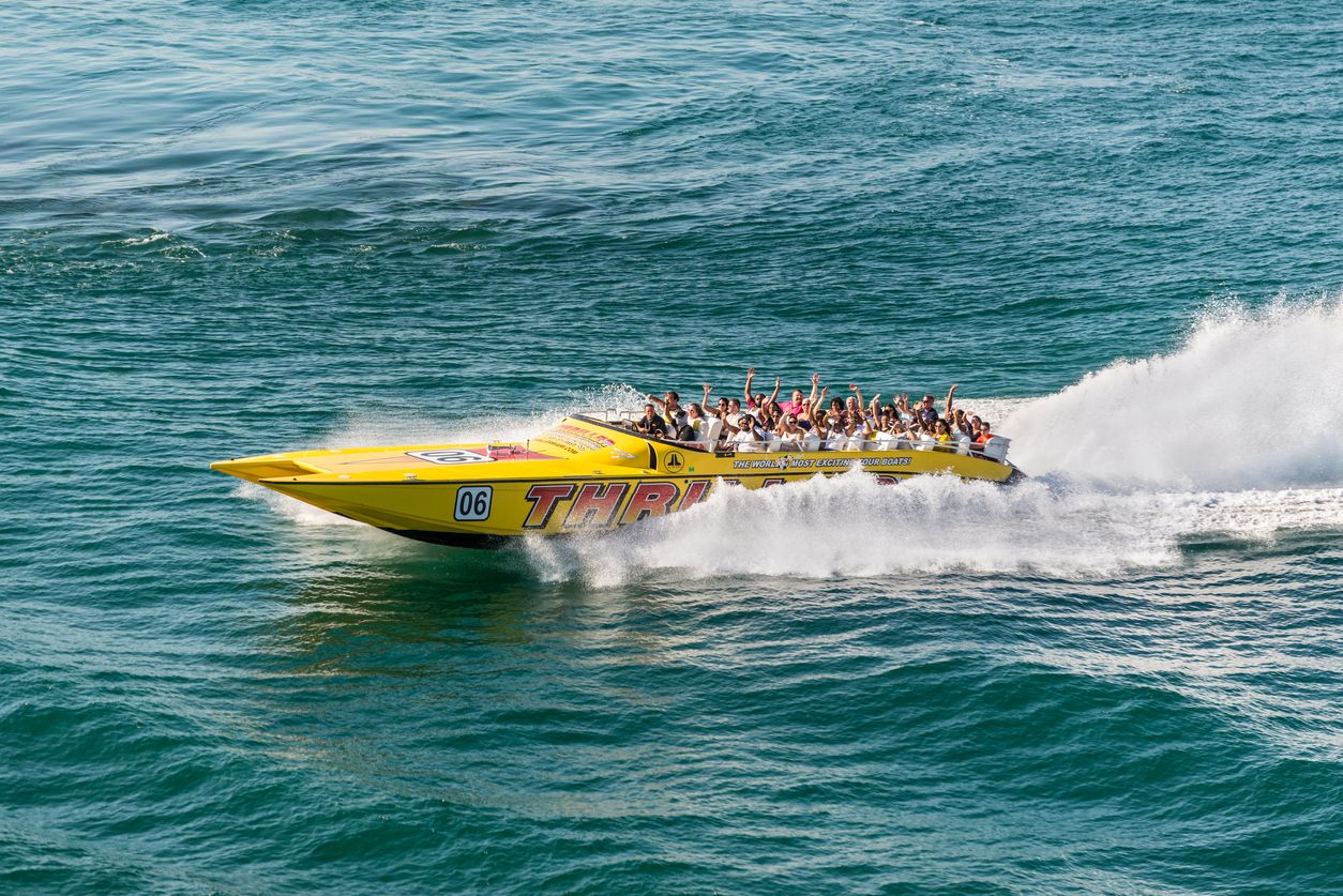 Tourists enjoying a high speed sightseeing boat tour of Miami and Miami Beach