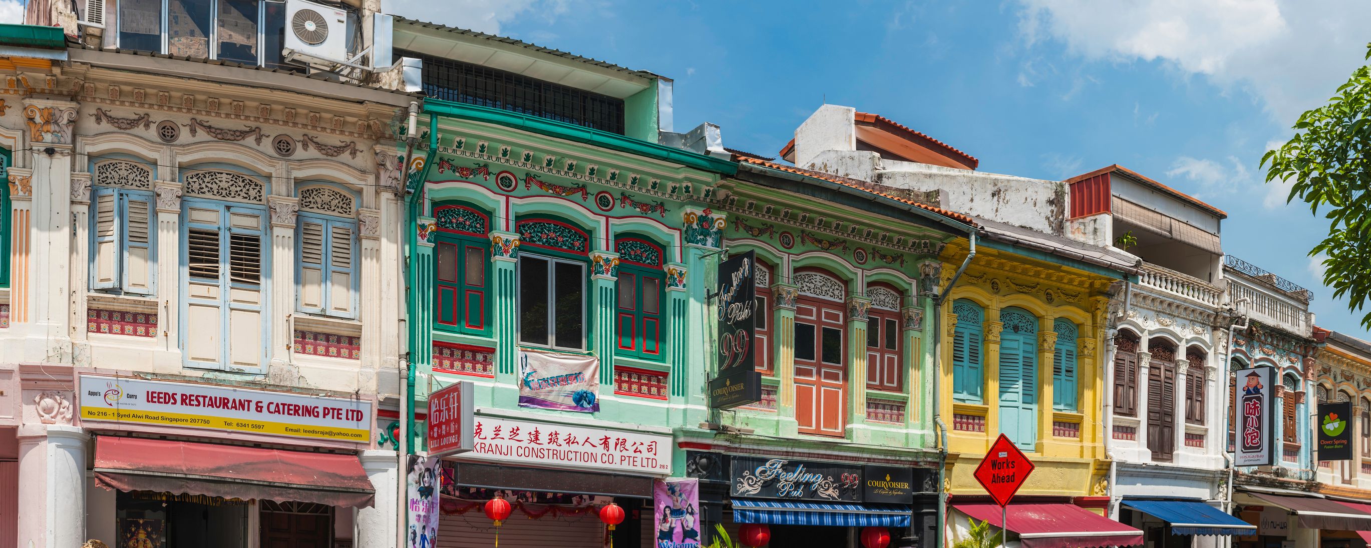 Colourful buildings shop and shutters panorama Little India Singapore