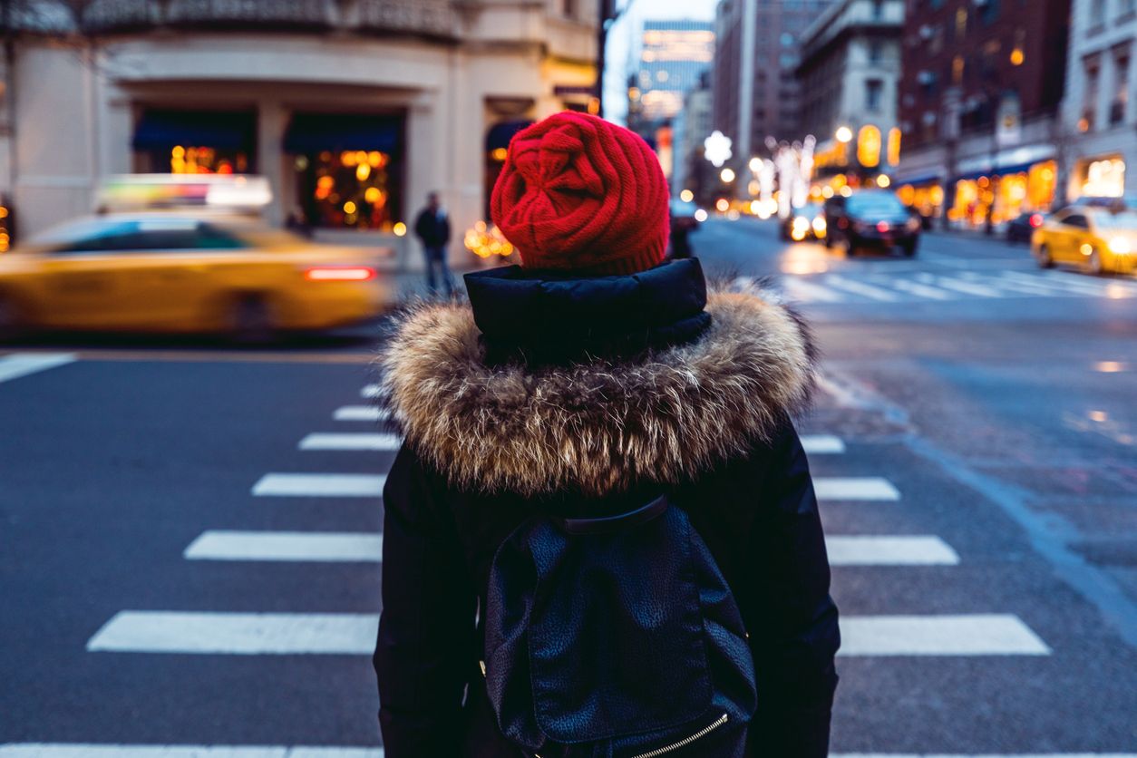 Woman waiting to cross the street in downtown Manhattan - New York City