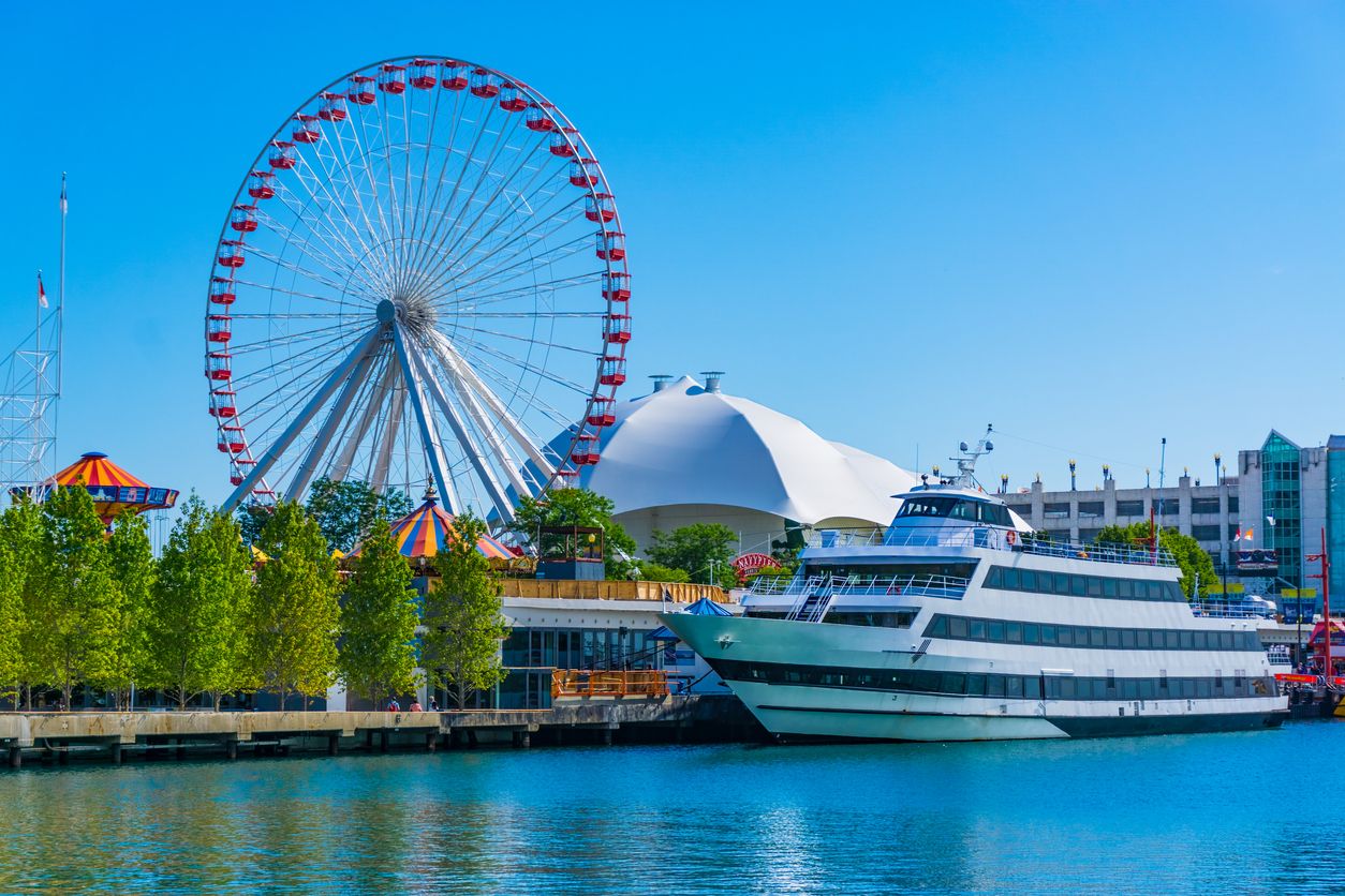 Chicago's Navy Pier and ferris wheel along the Chicago River with cruise ship