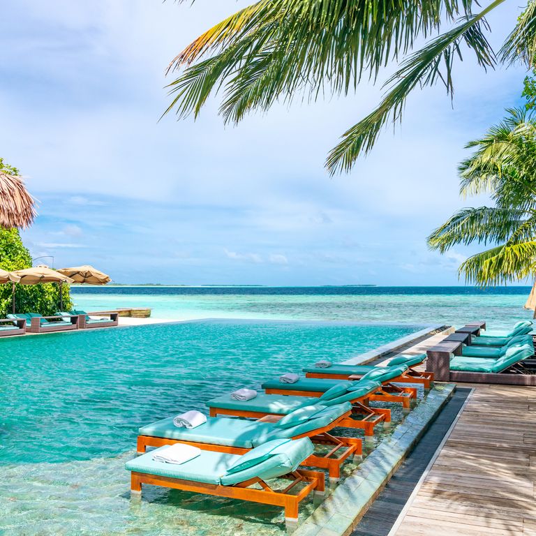 Tanning Beds Beside Swimming Pool in Tropical Resort in Maldives