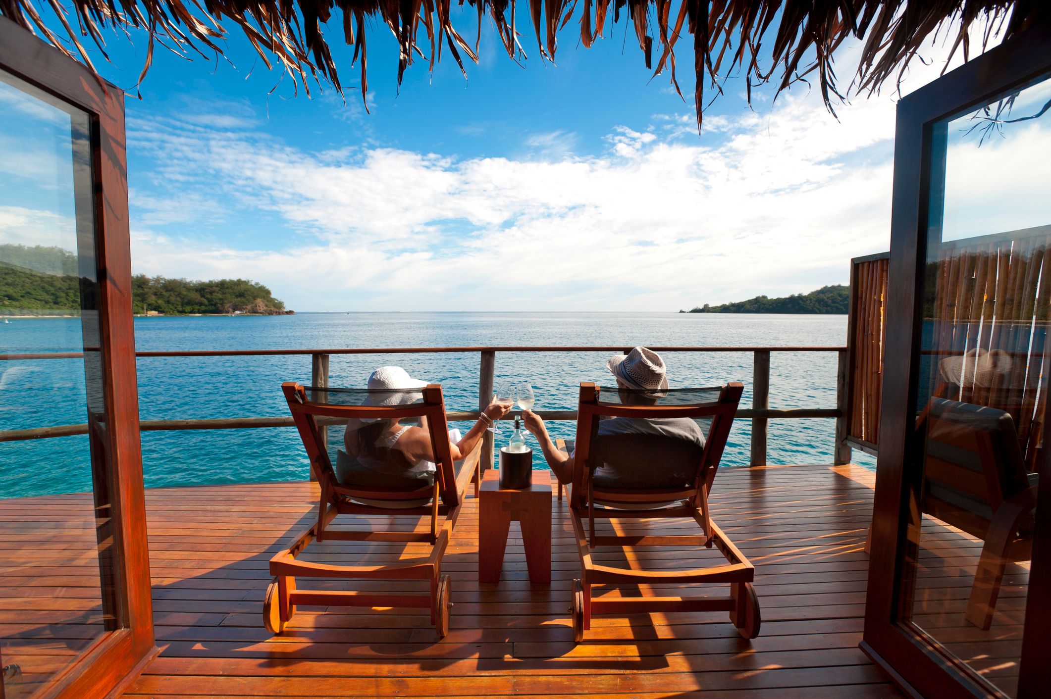 Couple relaxing in an over water bungalow in Fiji