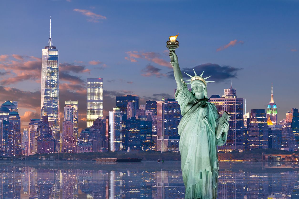Statue of Liberty and World Trade Center at sunset, NYC.