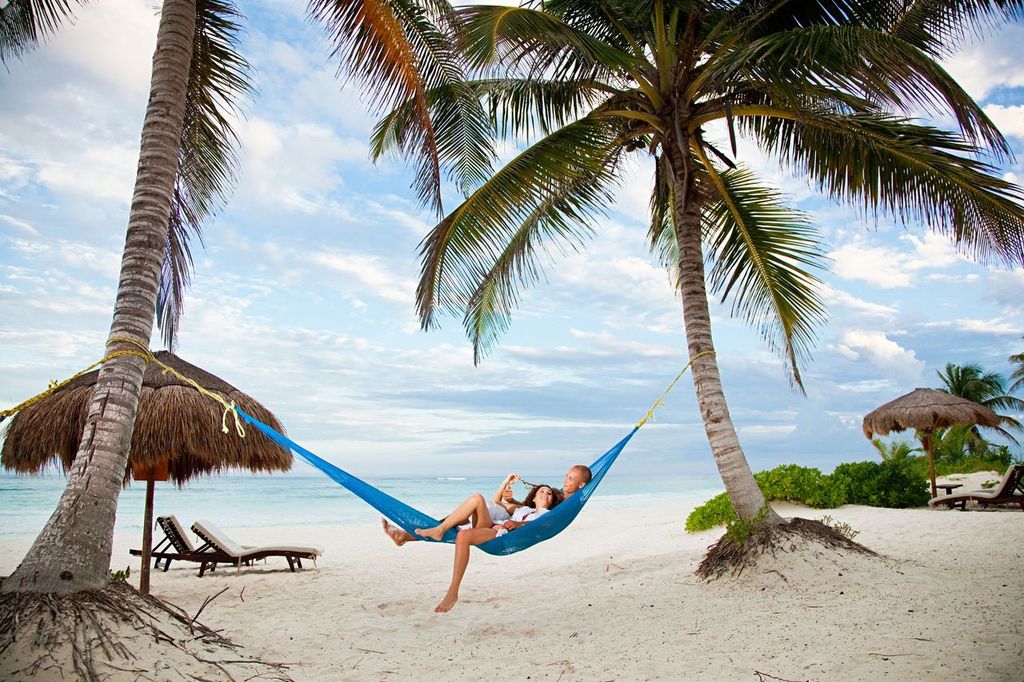 Couple together on a hammock on a Caribbean beach