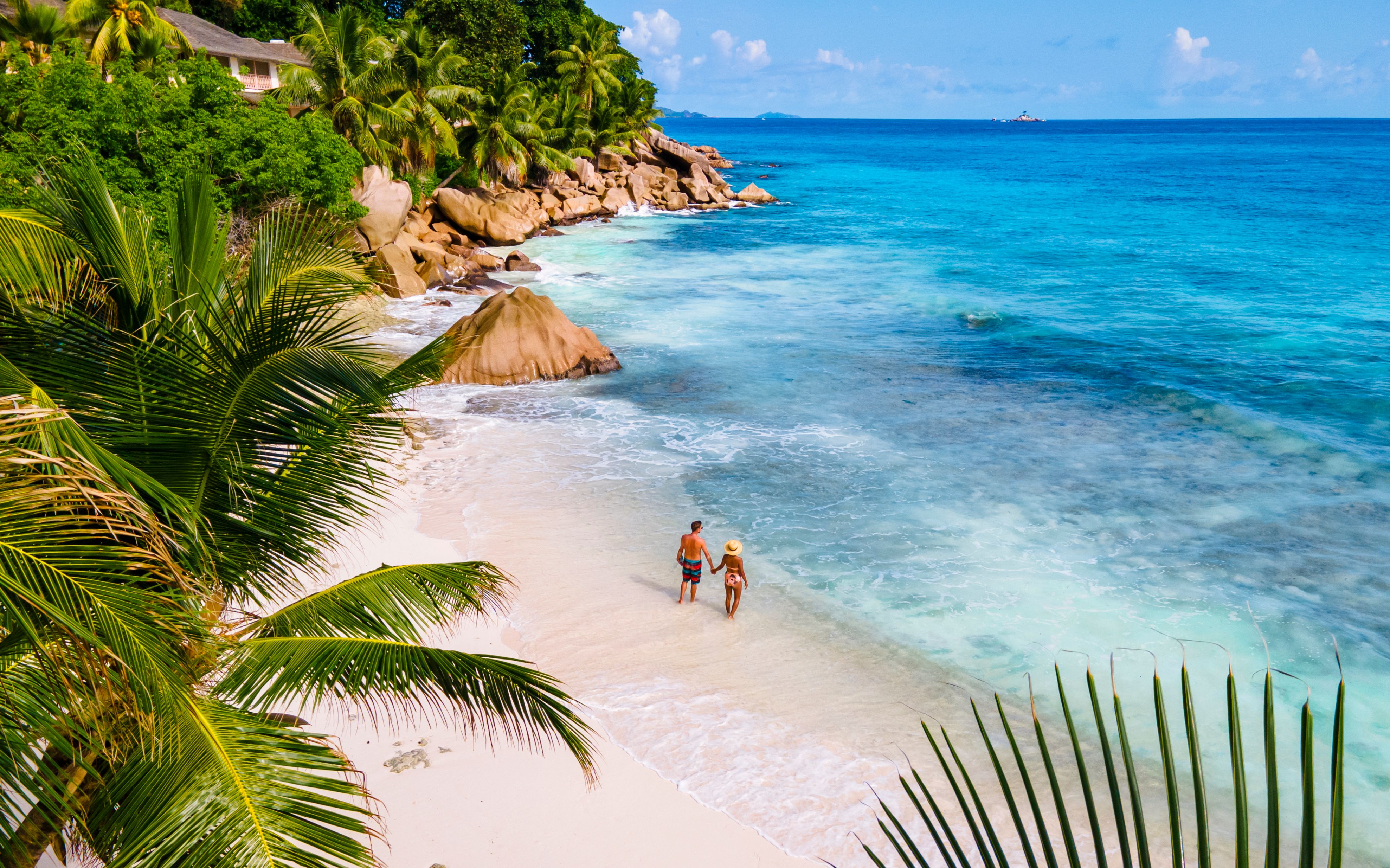 Young couple on a tropical beach during a luxury vacation in the Seychelles