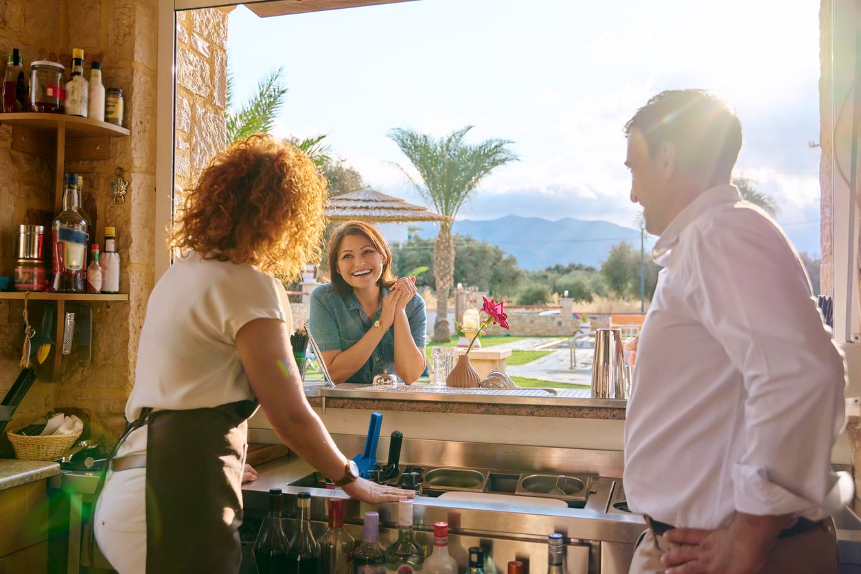 Resort staff serving a guest from the bar.