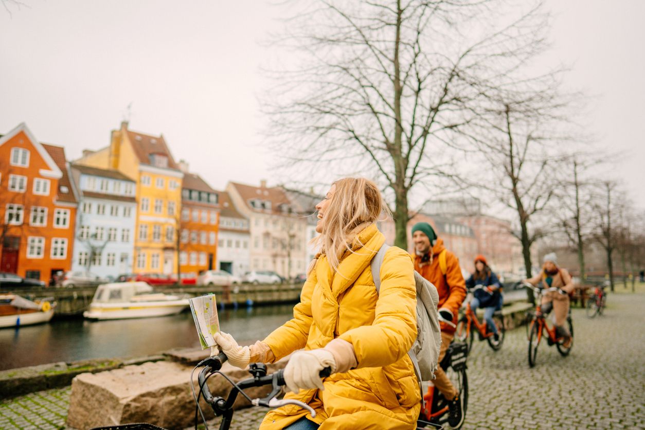 Travel guide and her group on the bicycles through the town.