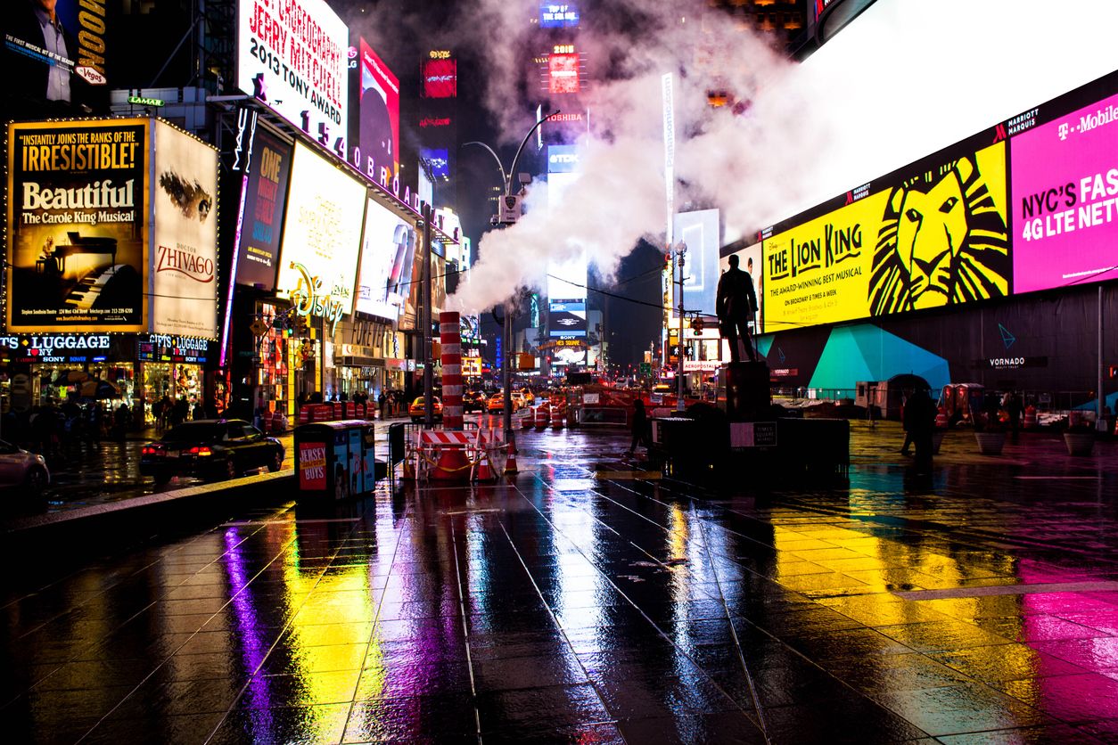 Times Square at Night with Broadway show billboards.