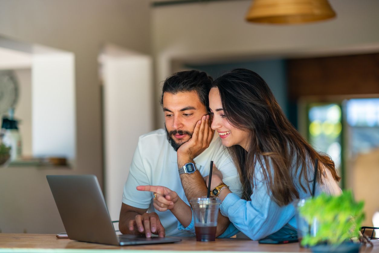 Couple looking at a laptop together