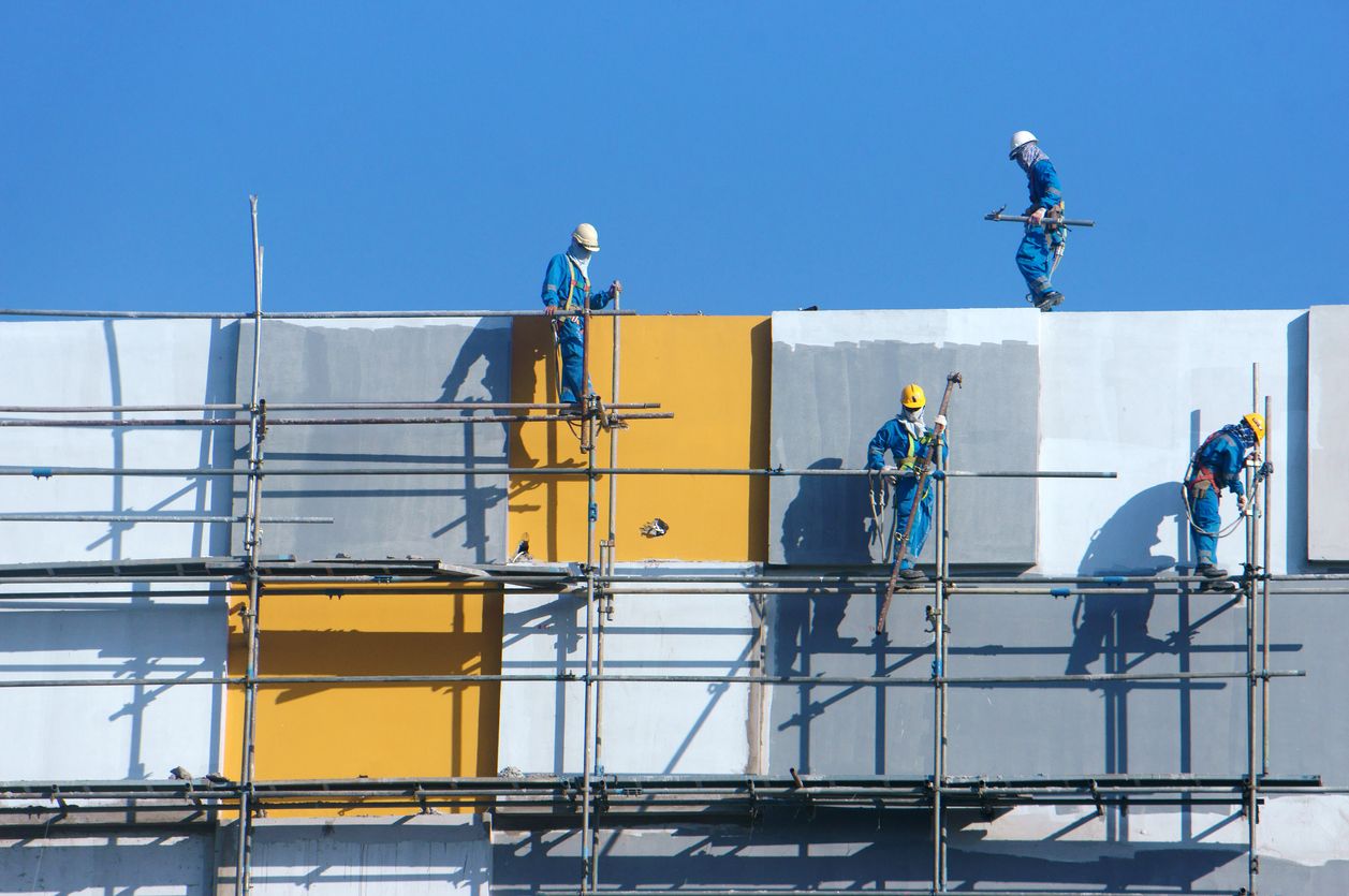 Vietnamese builders working on construction project in Saigon, Vietnam.