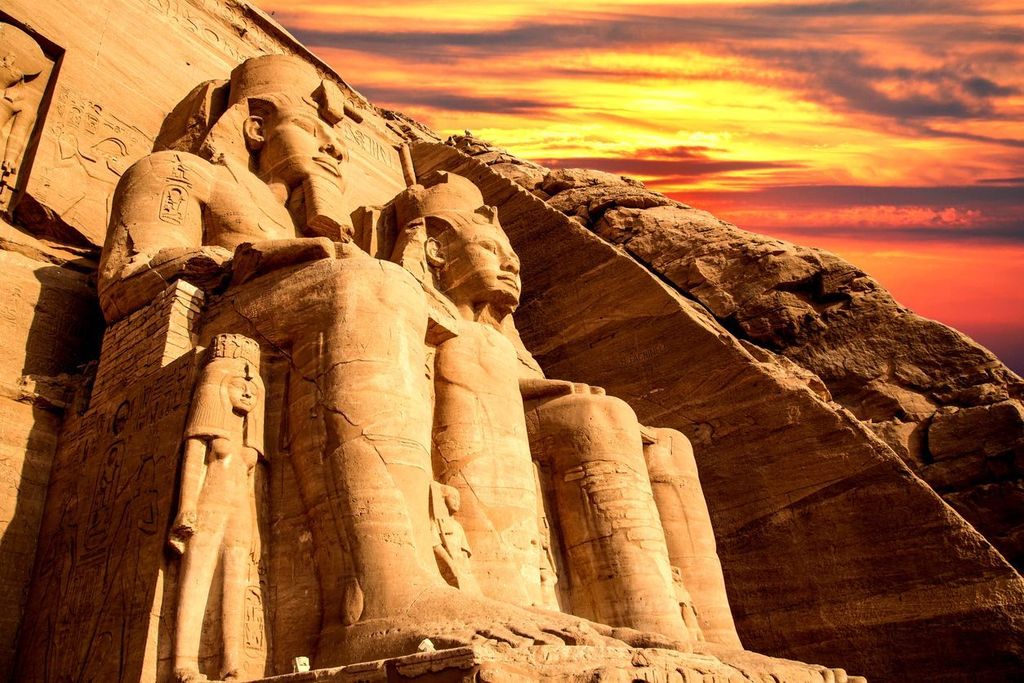 The sun setting over the temple of Abu Simbel in Egypt