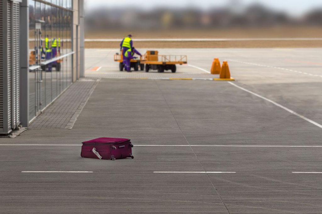 The suitcase lost by the airport staff lies on the ground