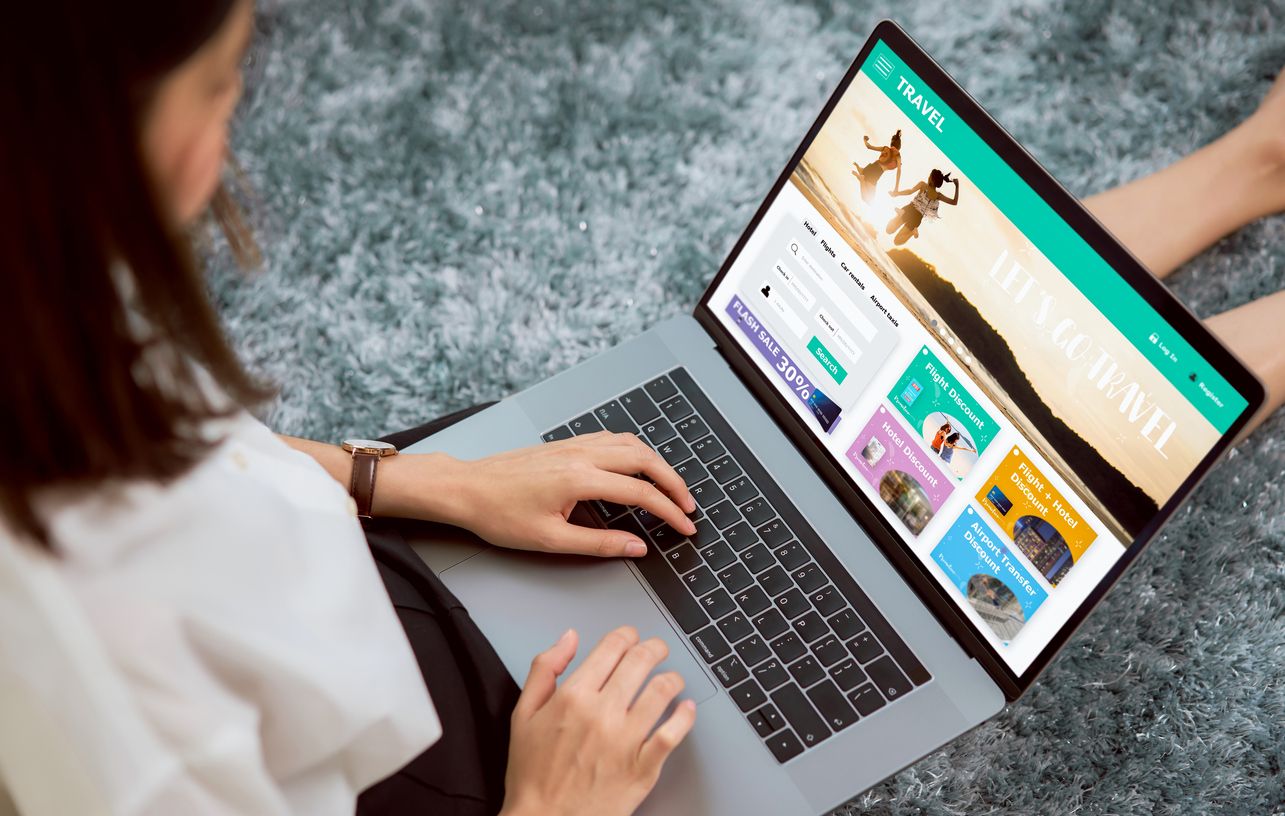 Woman sitting in her house with using laptop and booking flight travel