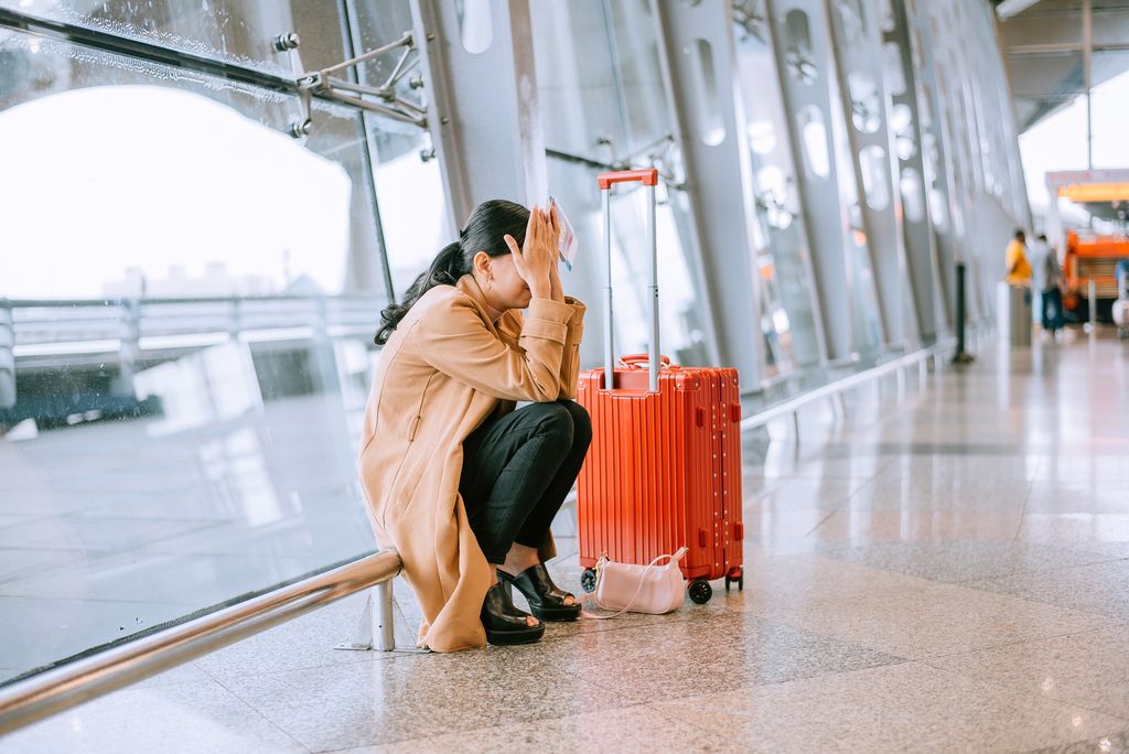 Young woman upset and frustrated while flight canceled at the airport