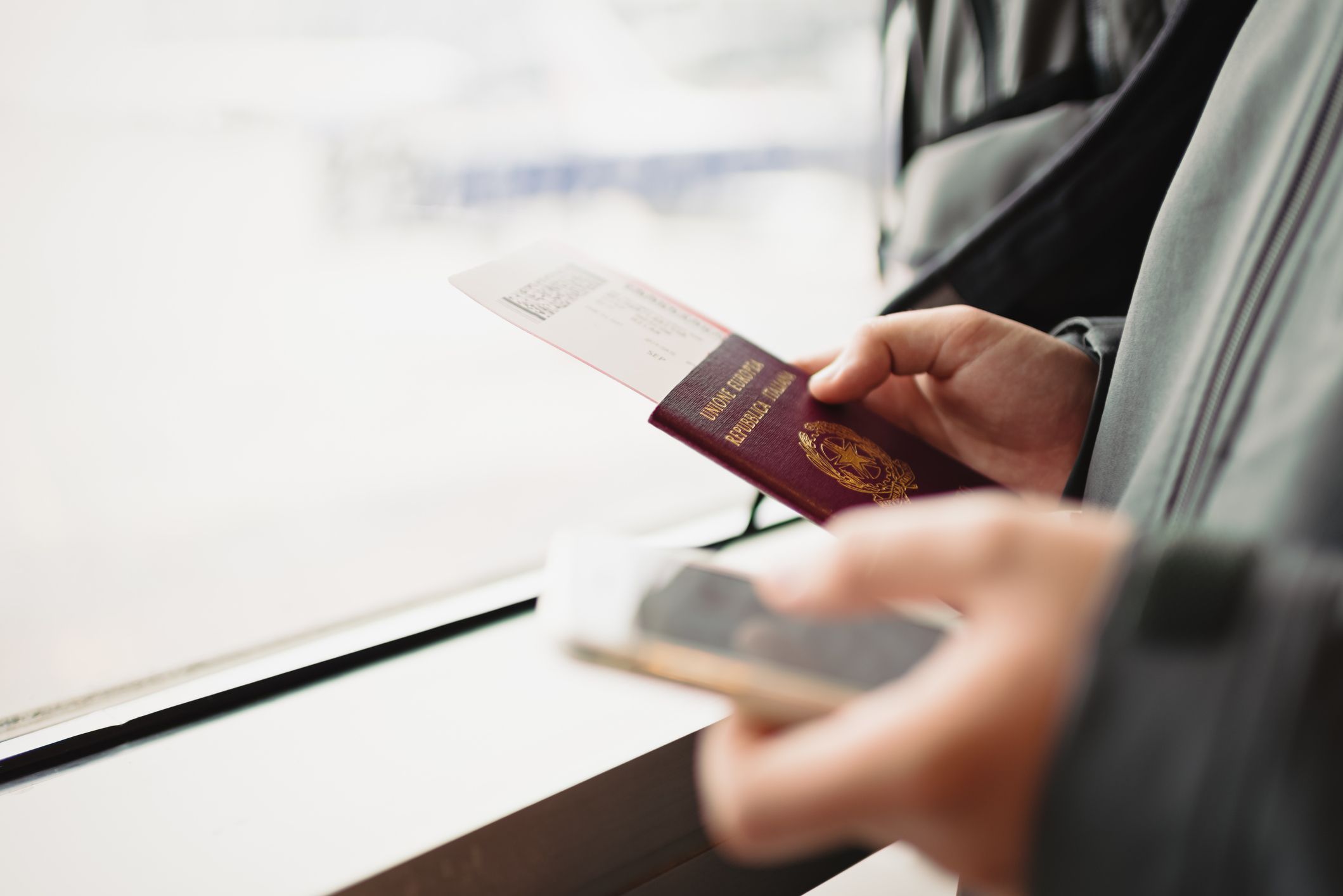 Male hands holding passport, ticket for plane