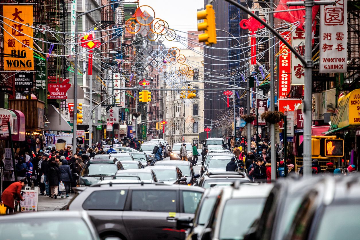 Traffic on busy streets of Manhattan Chinatown, New York City, USA