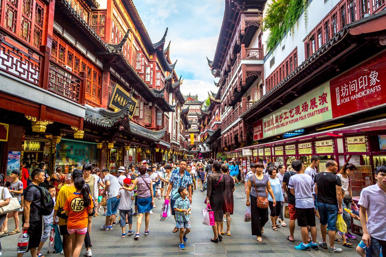 Locals and tourists enjoying a hot summer day in downtown Shanghai in China, Asia