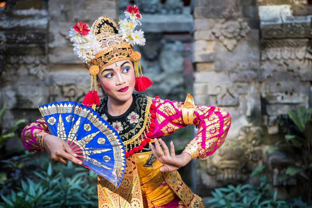 A young Bali female dancer is performing the Ramayana dance in a temple of Bali, in Indonesia