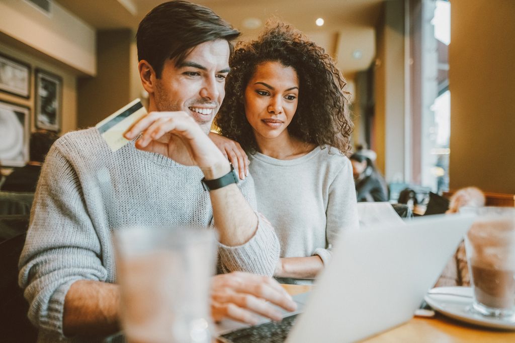 Couple in café is making online reservation for travel