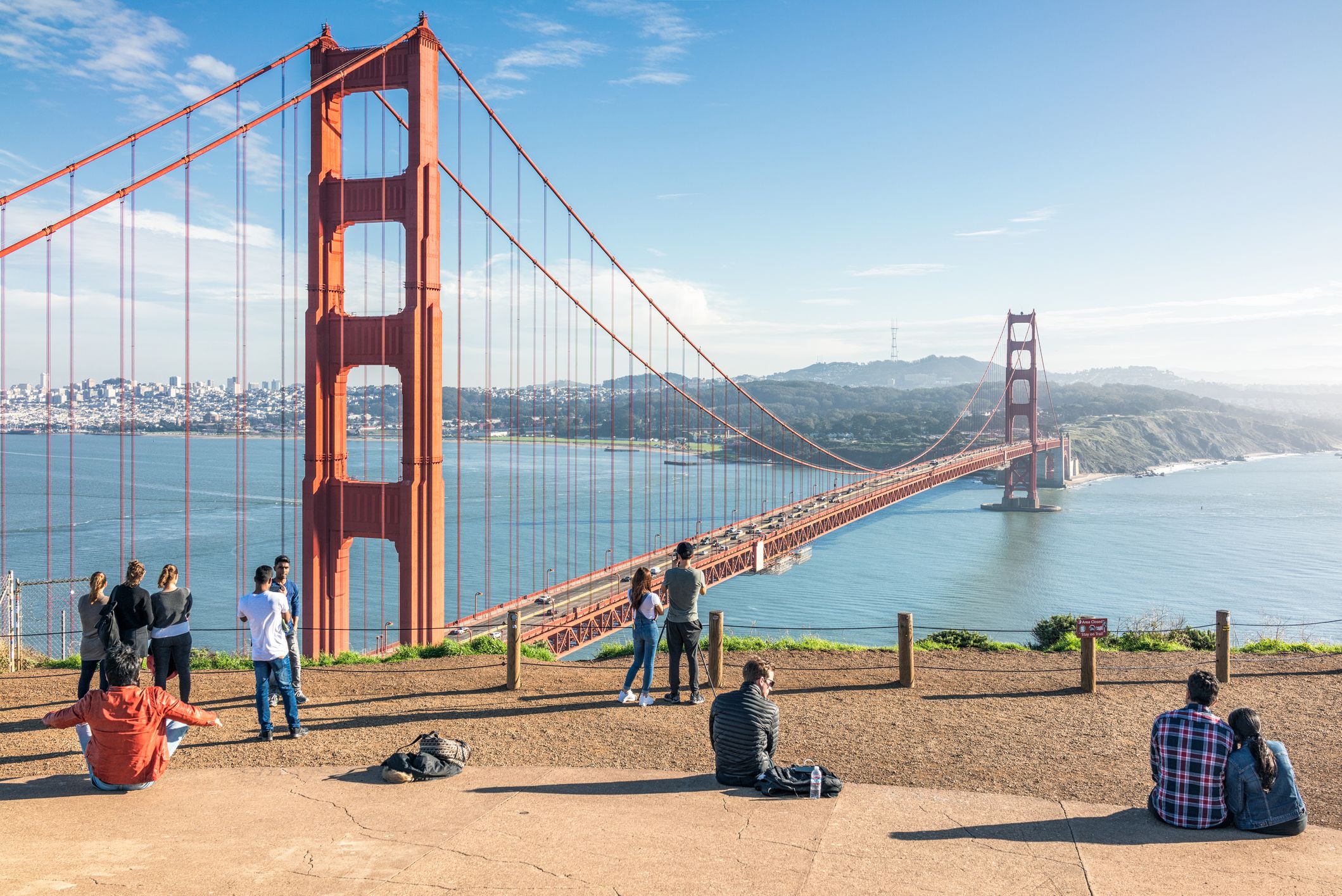 Tourists visiting a viewpoint above the iconic Golden Gate Bridge