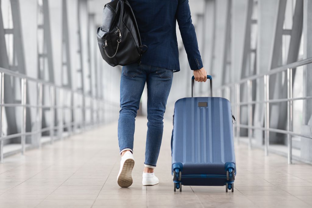  Man With Bag And Suitcase Walking In Airport