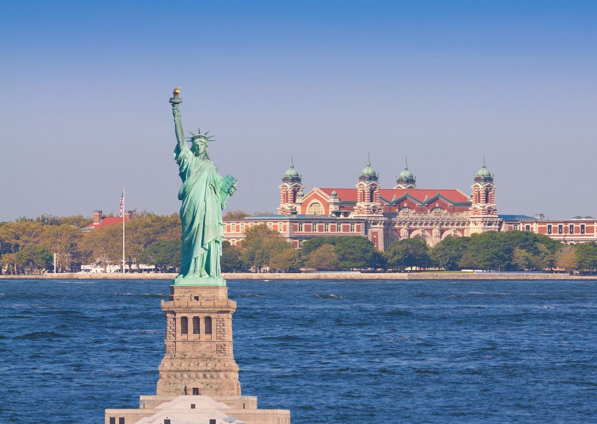 Statue of Liberty, Ellis Island, New York with morning blue sky