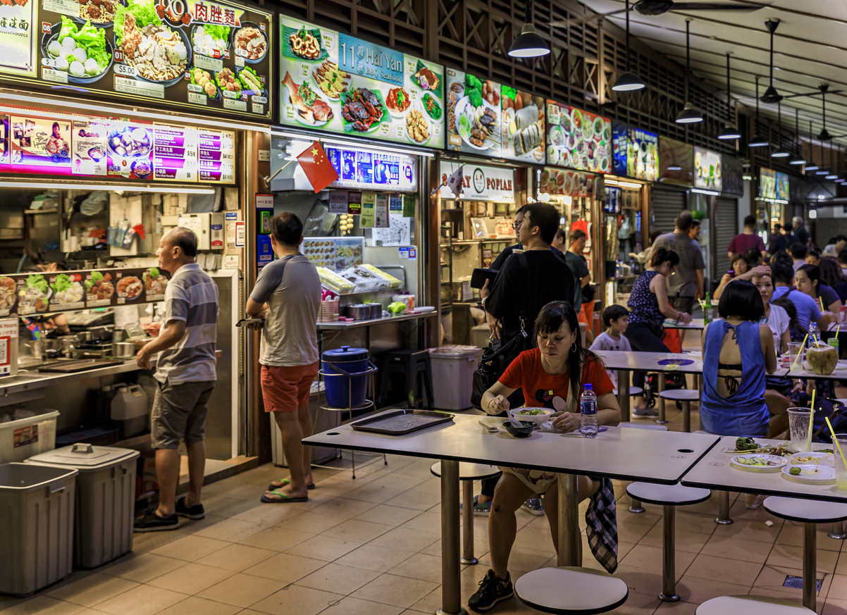 Locals and tourists, customers eating at the street hawker center in Lau Pa Sat Telok Ayer Market, Singapore