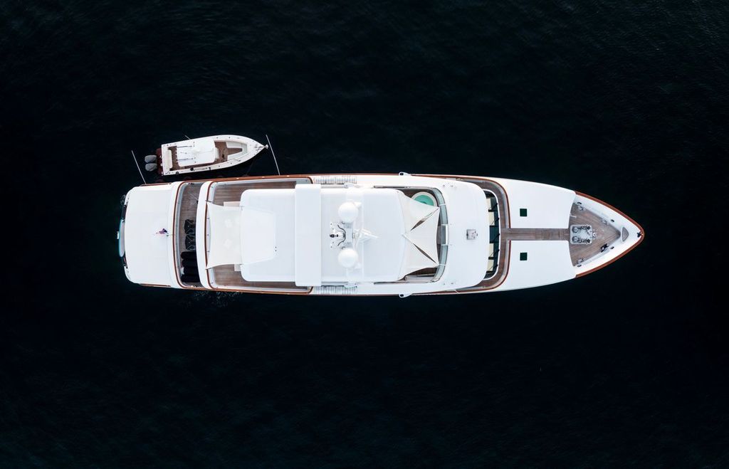 High angle aerial bird's eye view of a long white luxury yacht