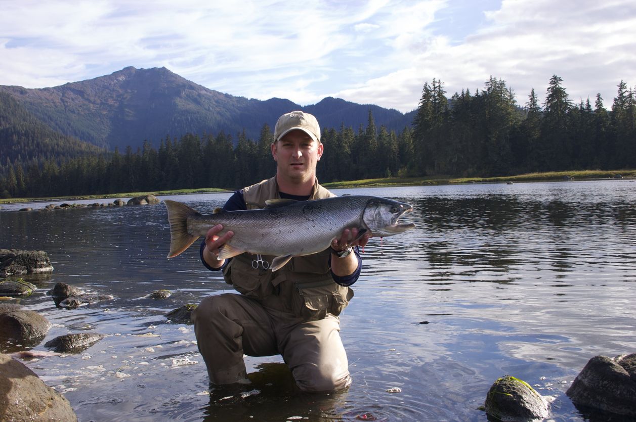 Fisherman holding an Alaskan Silver Salmon