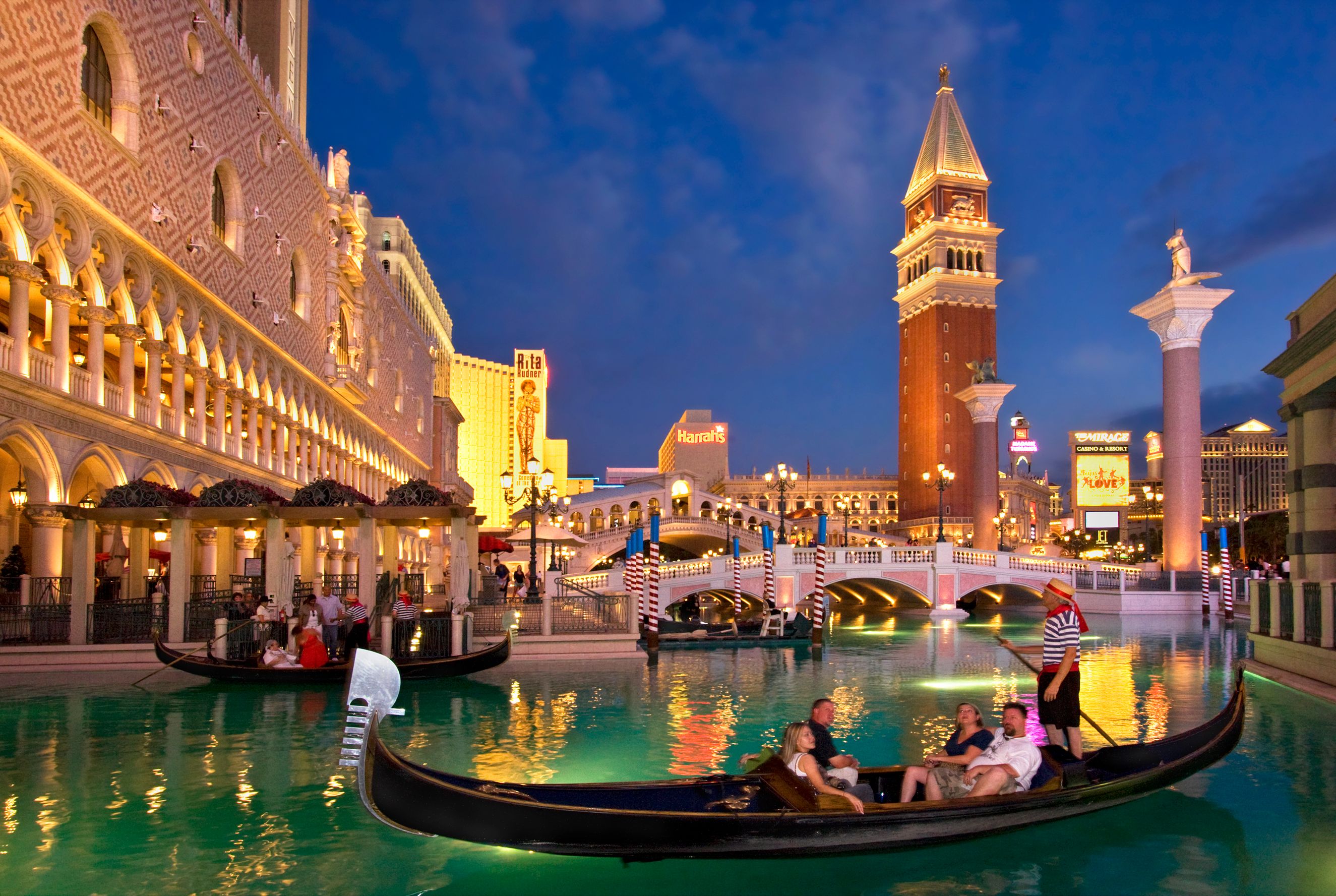 Gondolas at the Venetian Resort lagoon at night in Las Vegas, Nevada, USA.