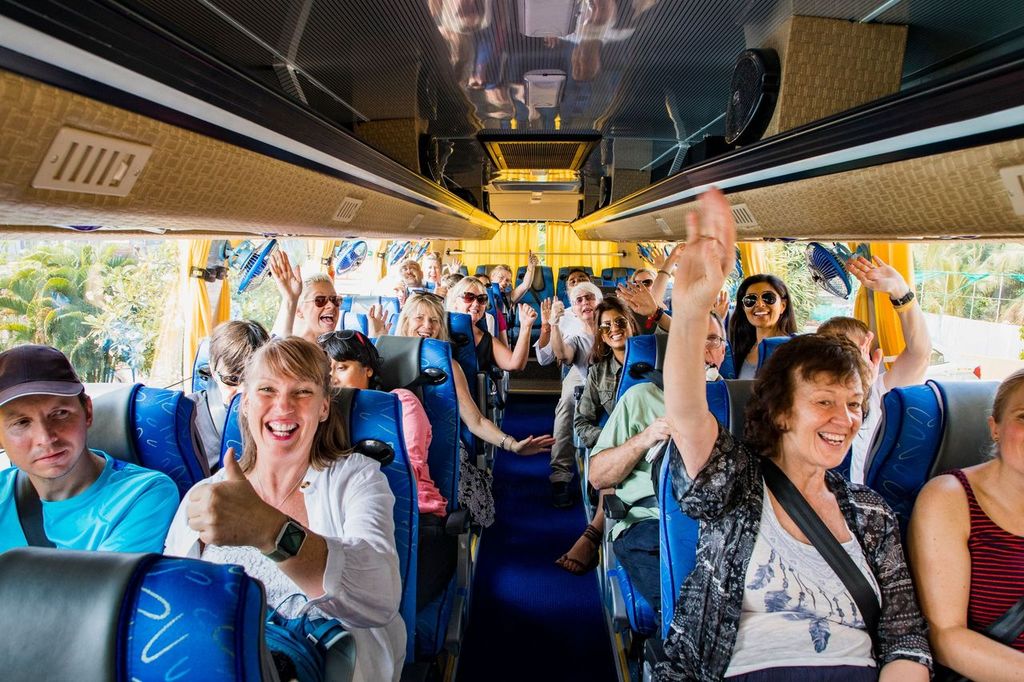 Group of tourists on a bus excited to travel