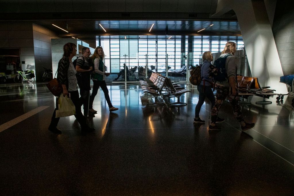  tourists walking together through an airport in India