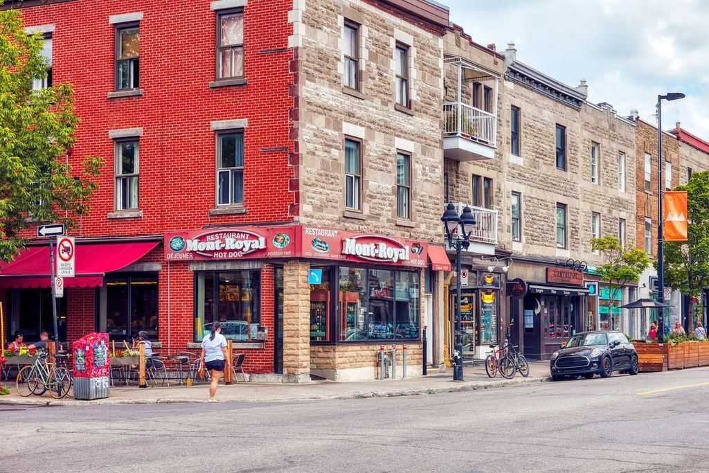 People, historical buildings and restaurants on Le Plateau Mont Royal street in Montreal